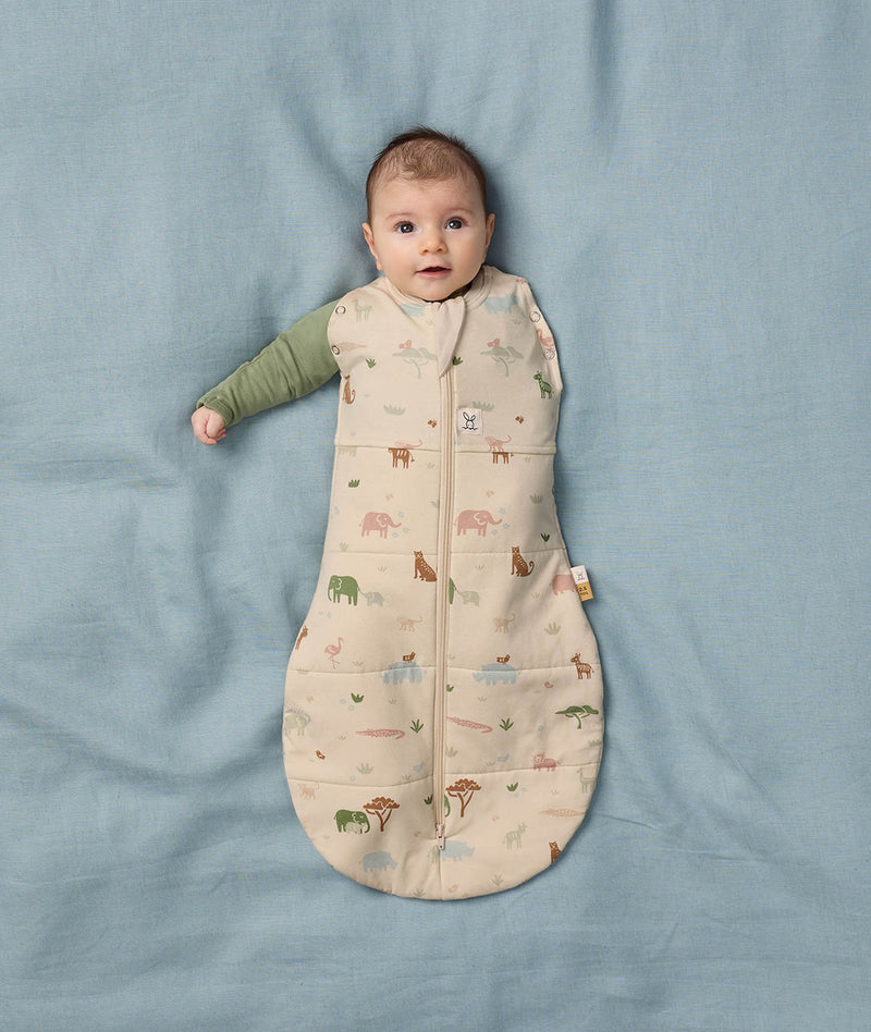 Baby wearing ergoPouch Cocoon Swaddle Sack with one arm out