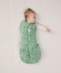 Newborn wearing ergoPouch Cocoon Swaddle Sack 2.5 TOG Sweet Orchard, transitioning to arms out sleeping