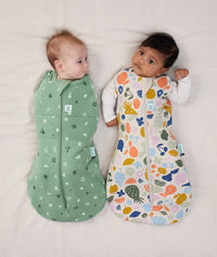 Two babies swaddled in ergoPouch Cocoon Swaddle Sack 2.5 TOG Sweet Orchard and Fruit Salad, warm for the winter