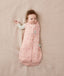 Baby wearing a ergoPouch Cocoon Swaddle Sack 3.5 TOG Daisies, transitioning to arms out sleeping