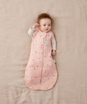 Baby sleeping with arms out in a ergoPouch Cocoon Swaddle Sack 2.5 TOG Daisies