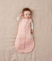 Baby sleeping with arms out in a ergoPouch Cocoon Swaddle Sack 2.5 TOG Daisies