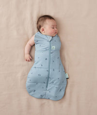 Baby wearing a ergoPouch Cocoon Swaddle Sack 3.5 TOG Dragonflies, transitioning to arms out sleeping