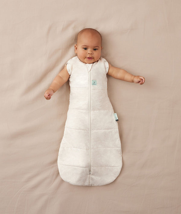 Baby sleeping with arms out in a ergoPouch Cocoon Swaddle Sack 2.5 TOG Oatmeal Marle