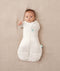 Baby wearing a ergoPouch Cocoon Swaddle Sack 3.5 TOG Oatmeal Marle, transitioning to arms out sleeping