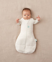 Baby sleeping with arms out in a ergoPouch Cocoon Swaddle Sack 3.5 TOG Oatmeal Marle
