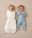 Two babies asleep in ergoPouch Cocoon Swaddle Sack 2.5 TOG Oatmeal Marle and Long Sleeve Romper