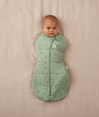 Newborn being swaddled in a ergoPouch Cocoon Swaddle Sack 2.5 TOG Willow