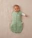 Baby wearing a ergoPouch Cocoon Swaddle Sack 3.5 TOG Willow, transitioning to arms out sleeping