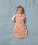 Newborn transitioning to arms out sleeping in an ergoPouch Cocoon Swaddle Sack 3.5 TOG Elephant Parade, perfect for winter