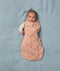 Newborn transitioning to arms out sleeping in an ergoPouch Cocoon Swaddle Sack 3.5 TOG Elephant Parade, perfect for winter