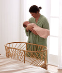 Baby swaddled by mothers wearing a ergoPouch Cocoon Swaddle Sack 1.0 TOG Daisies