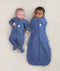 Two newborns wearing ergoPouch Cocoon Swaddle Sack 0.2 TOG and Long Sleeve Romper in Night Sky