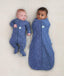Two newborns wearing ergoPouch Cocoon Swaddle Sack 0.2 TOG and Long Sleeve Romper in Night Sky