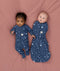 Two babies wearing Starbeam sleepwear, one in Long Sleeve Romper 1.0 TOG and the other in Cocoon Swaddle Sack 1.0 TOG