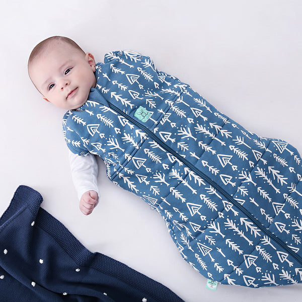 Baby wearing a Cocoon Swaddle Sack with its one arm out