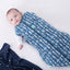 Baby wearing a Cocoon Swaddle Sack with its one arm out