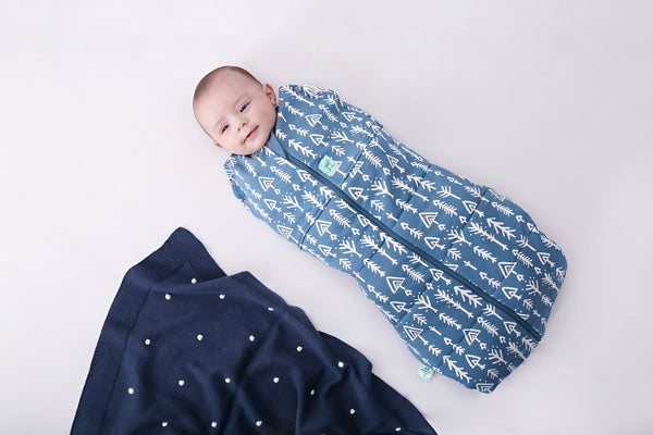 Baby wearing a Cocoon Swaddle Sack Midnight Arrows