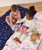 DreamRoll All-in-One Sleep Mat preschoolers sitting next each other