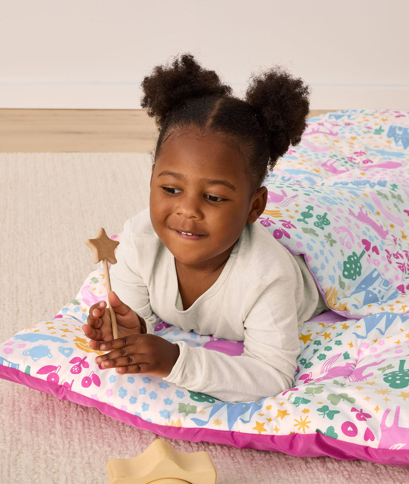 DreamRoll All-in-One Sleep Mat Unicorn Dreams preschooler lying on tummy