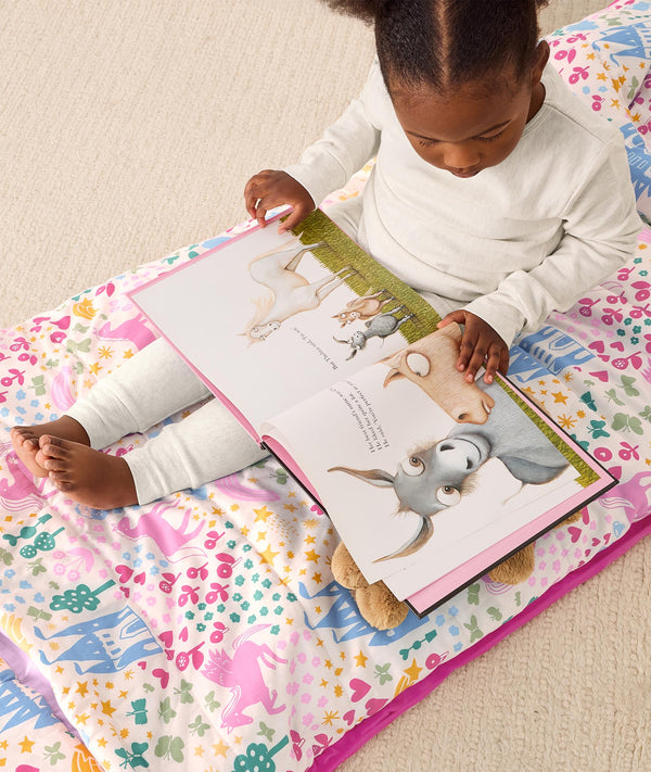 DreamRoll All-in-One Sleep Mat Unicorn Dreams reading a book sitting on mat