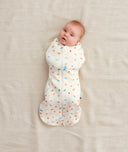 Newborn swaddled in ergoPouch Cocoon Swaddle Sack 0.2 TOG Desert Bloom, perfect for summer