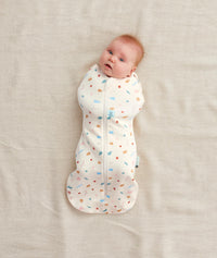 Newborn swaddled in ergoPouch Cocoon Swaddle Sack 0.2 TOG Desert Bloom, perfect for summer