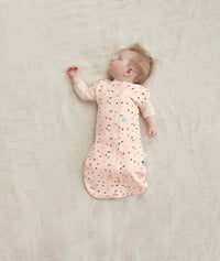 Newborn in a ergoPouch Cocoon Swaddle Sack 1.0 TOG Cute Fruit, arms out sleeping 