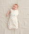 Newborn in a ergoPouch Cocoon Swaddle Sack 1.0 TOG Desert Bloom, transitioning to arms out sleeping 