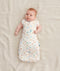 Newborn in a ergoPouch Cocoon Swaddle Sack 1.0 TOG Desert Bloom, transitioning to arms out sleeping 