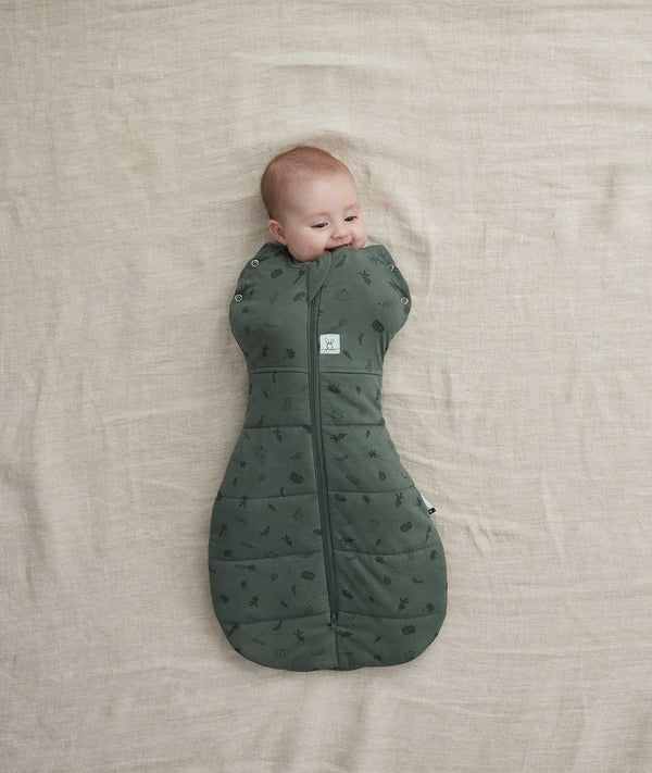 Baby wearing an ergoPouch Cocoon Swaddle Sack 2.5 TOG Veggie Patch