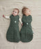 Two babies lying side by side wearing Cocoon Swaddle Sacks. One wearing a 2.5 TOG, while the other one is wearing a 1.0 TOG