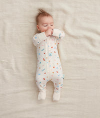 Baby wearing  ergoPouch Long Sleeve Romper 0.2 TOG Desert Bloom, with foot cuffs covered to keep the feet warm