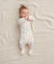 Baby wearing  ergoPouch Long Sleeve Romper 0.2 TOG Desert Bloom, with foot cuffs covered to keep the feet warm