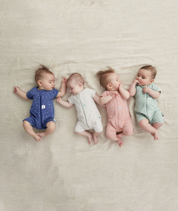 Four newborns ergoPouch Short Sleeve Romper 0.2 TOG Berries Night Sky, Grey Marle and Sage, ideal for the summer