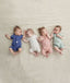 Four newborns ergoPouch Short Sleeve Romper 0.2 TOG Berries Night Sky, Grey Marle and Sage, ideal for the summer