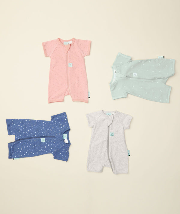 Flatlay of ergoPouch Short Sleeve Romper 0.2 TOG Berries Night Sky, Grey Marle and Sage, ideal for the summer