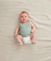 Newborn wearing the ergoPouch Bodywear Singlet in Sage