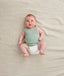 Newborn wearing the ergoPouch Bodywear Singlet in Sage