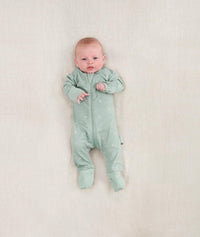 Newborn wearing the ergoPouch Long Sleeve Romper 0.2 TOG Sage