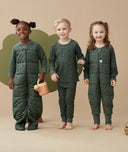 Three children wearing ergoPouch Sleep Suit Sack 2.5 TOG,  Long Sleeve Pajamas, and Sleep Onesie in print  Veggie Patch