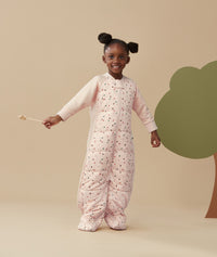 Child standing in an ergoPouch Sleep Suit Sack 3.5 TOG Cute Fruit, a warm sleeping bag that converts to a sleeping bag with legs