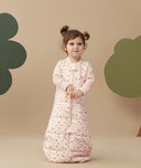 Child standing in an ergoPouch Sleep Suit Sack 3.5 TOG Cute Fruit, a warm sleeping bag that converts to a sleeping bag with legs