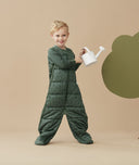 Child standing in an ergoPouch Sleep Suit Sack 3.5 TOG Veggie Patch, a warm sleeping bag that converts to a sleeping bag with legs