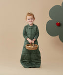 Child standing in an ergoPouch Sleep Suit Sack 3.5 TOG Veggie Patch, a warm sleeping bag that converts to a sleeping bag with legs