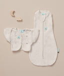 Flatlay of a newborn essential starter kit including ergoPouch Cocoon Swaddle Sack 1.0 TOG and Butterfly Cardi in heritage color Oatmeal Marle 