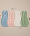 Flatlay of ergoPouch Summer Cocoon Swaddle Sack 0.2 TOG in Dragonflies, Daisies, Oatmeal Marle and Willow