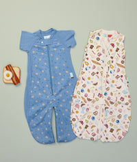 Flatlay of ergoPouch Jersey Sleep Suit Sack 0.2 TOG Bon Appetit and Sleep Suit Sack 1.0 TOG Petit Pretzel