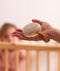 ergoPouch  White Noise Machine being held in a hand, featuring seven different soothing sounds