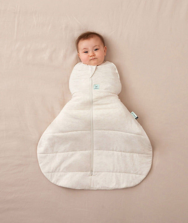 Newborn swaddled in ergoPouch Hip Harness Cocoon Swaddle Sack 2.5 TOG Oatmeal Marle